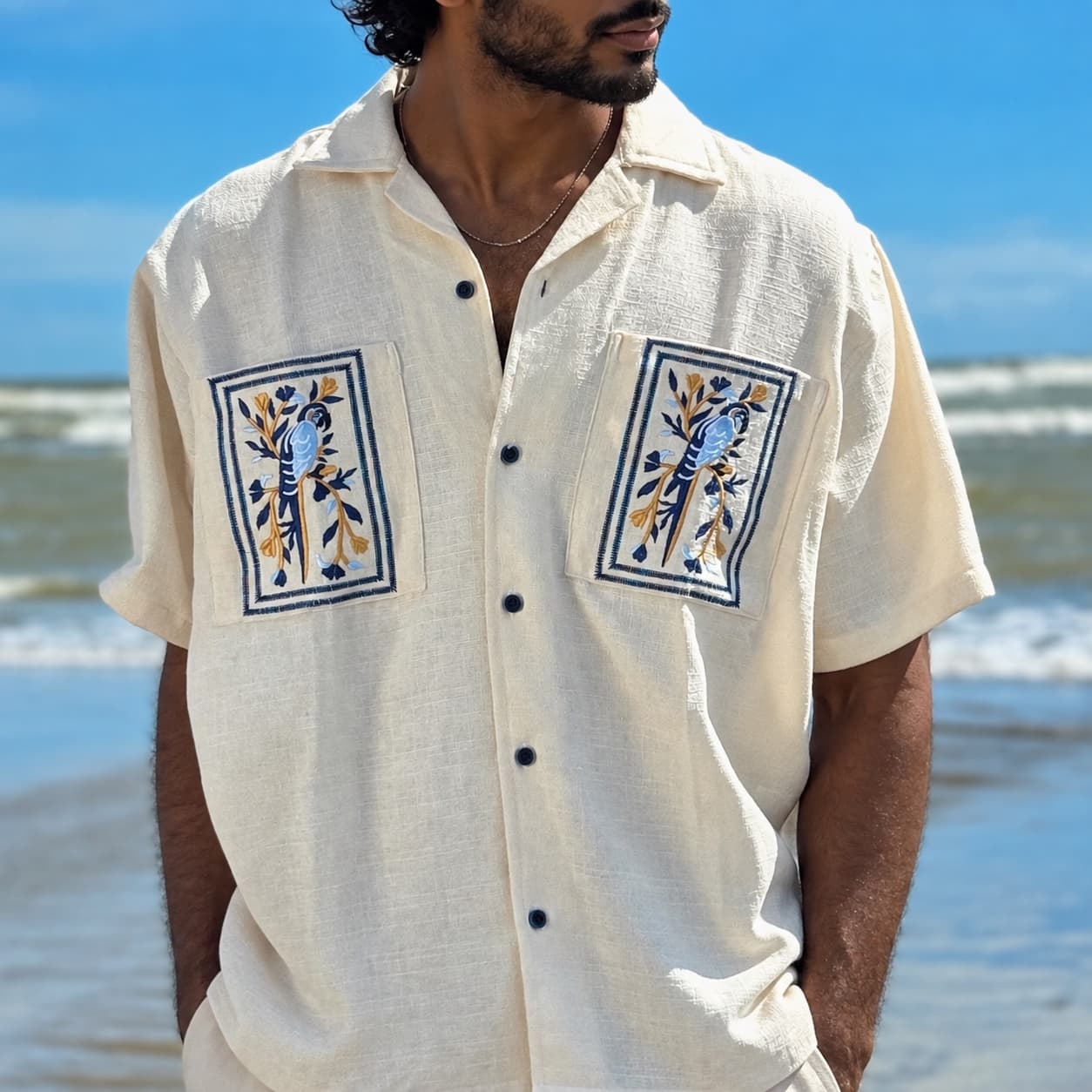 Ivory camp shirt with framed parrot embroidery on the pockets and back — Wear Indo ready-to-wear by Bangladeshi fashion designer Narin Juhi
