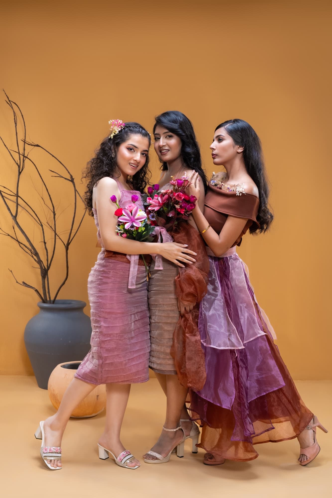 Petal Remains BUFT Graduation Couture Collection 2026 by Bangladeshi fashion designer Narin Juhi — three models in pink and violet organza with bouquets on the BUFT graduation runway, Dhaka